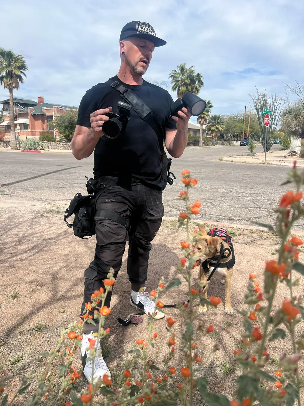 Wesley Parrish on location — camera in hand, service dog alongside
